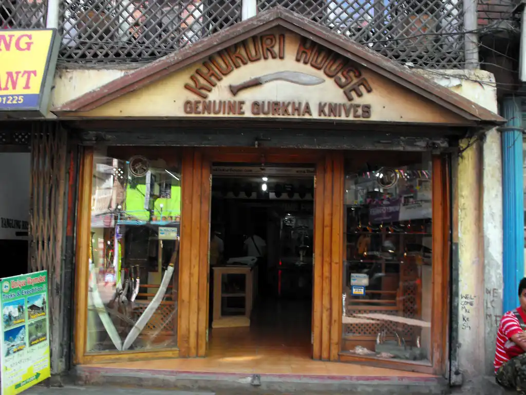 Khukuri House storefront in Kathmandu displaying genuine Gurkha knives with wooden entrance and glass windows.
