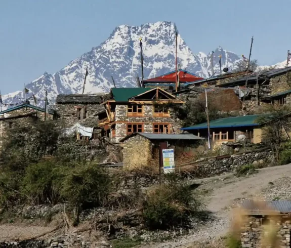 Traditional stone houses in Tsum Valley with the Himalayas in the background.