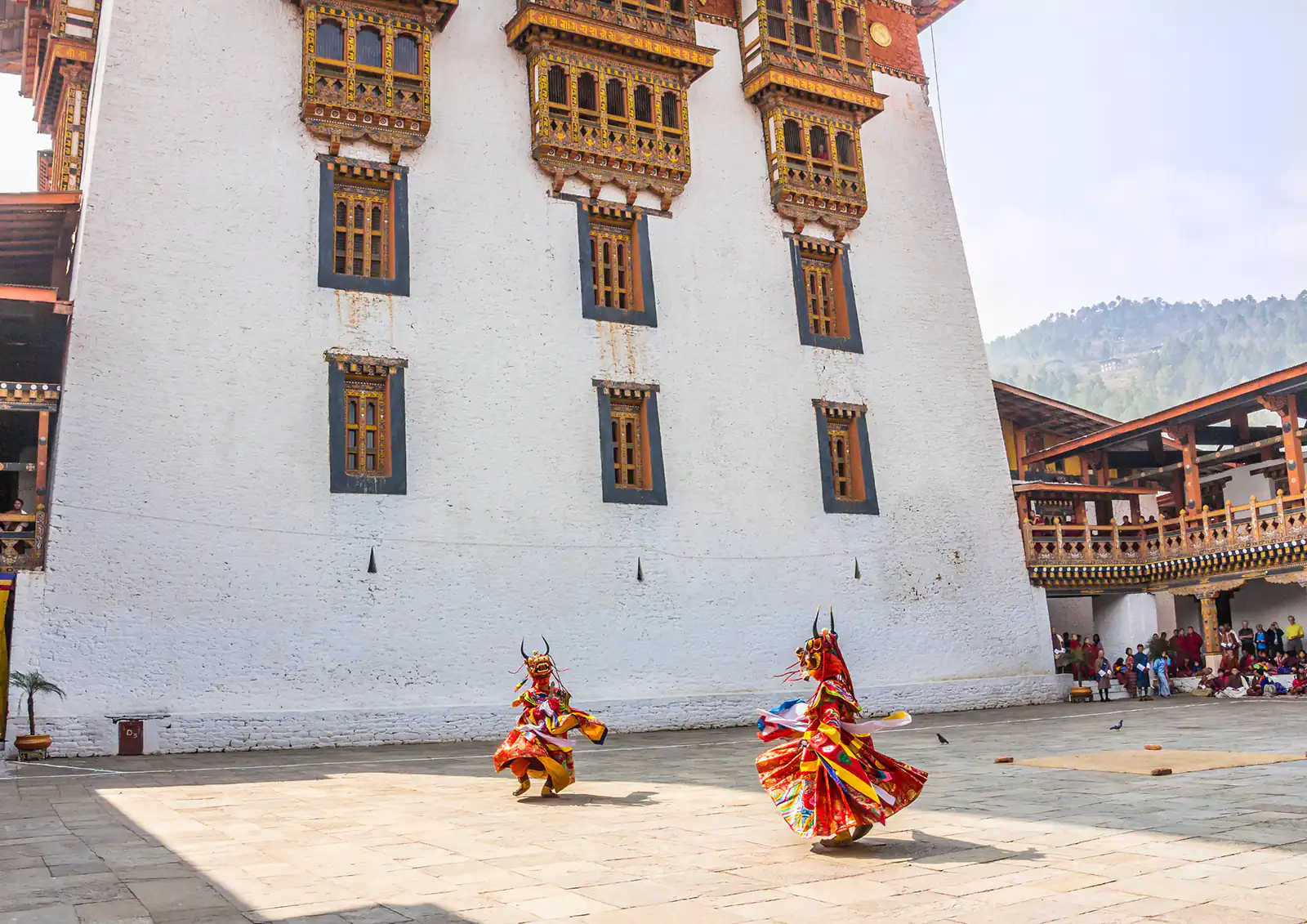 Two masked dancers perform at Bhutan's annual drunken festival, held in the Punakha dzong every March.