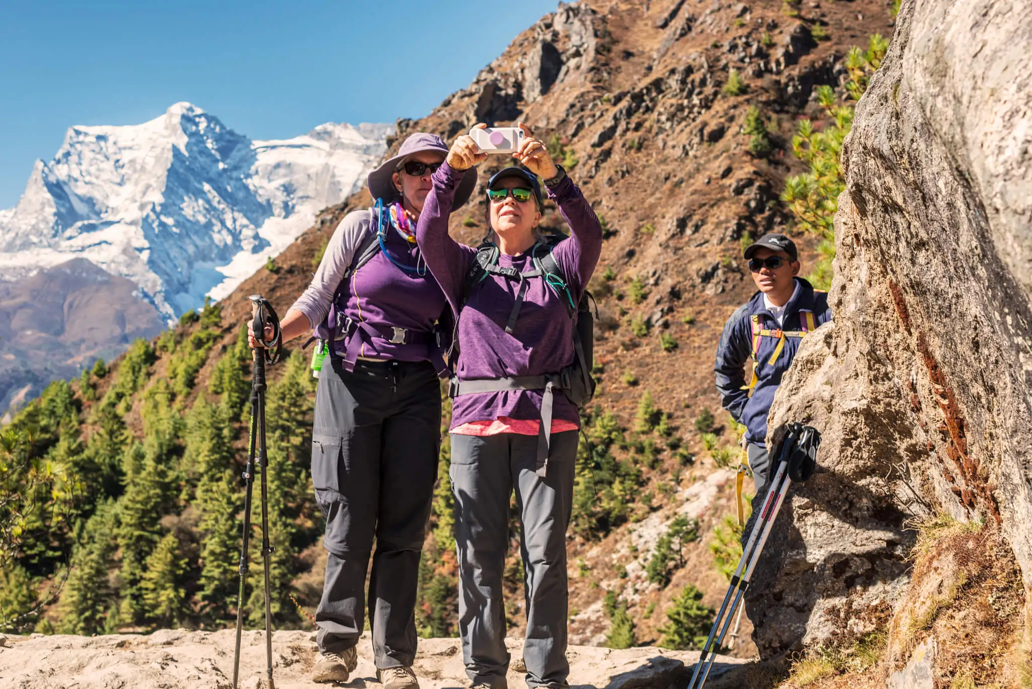 Two young girls taking pictures when trekking in Himalaya to Everest Base Camp in Nepal.
