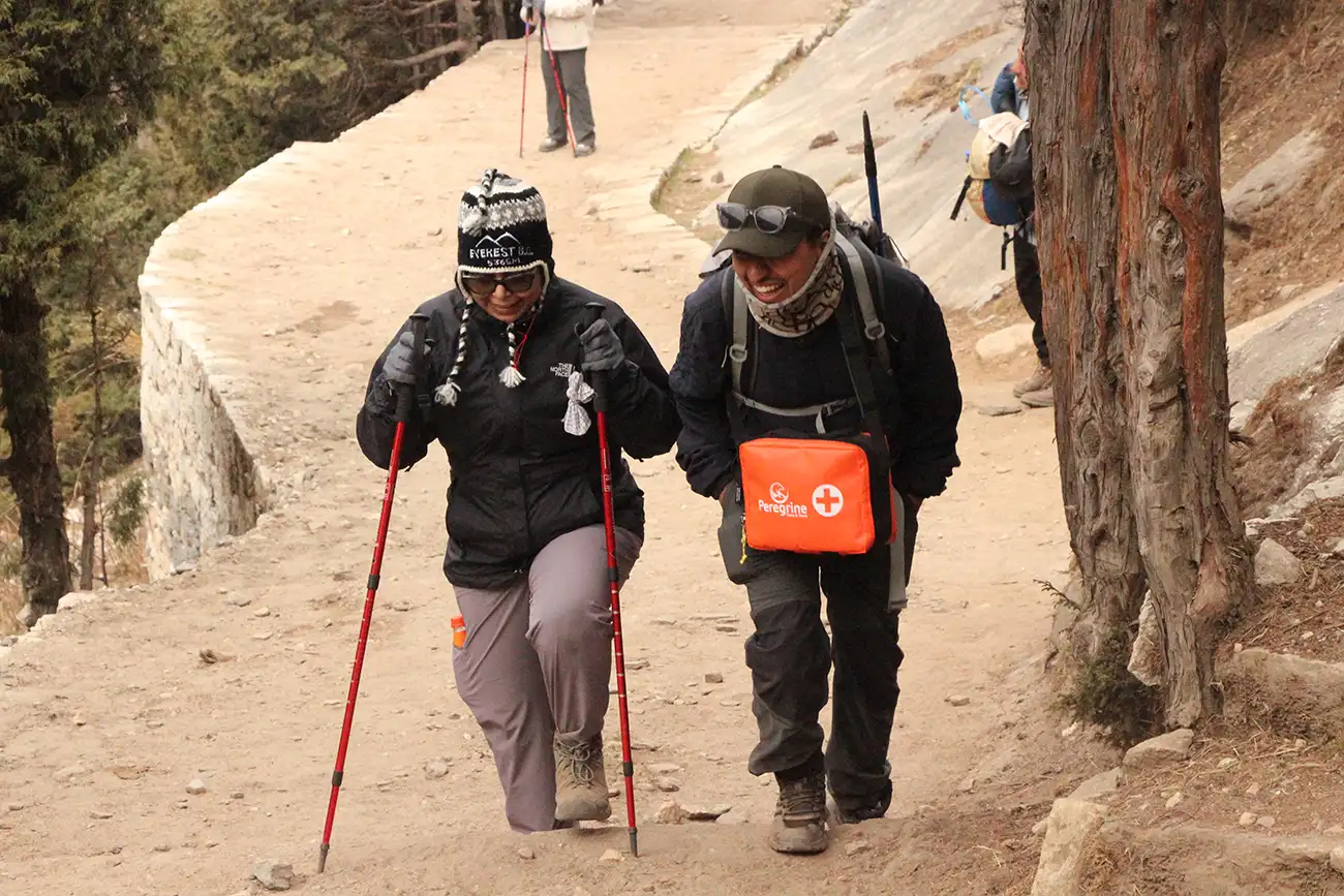 Guide with trekker with First Aid Kit