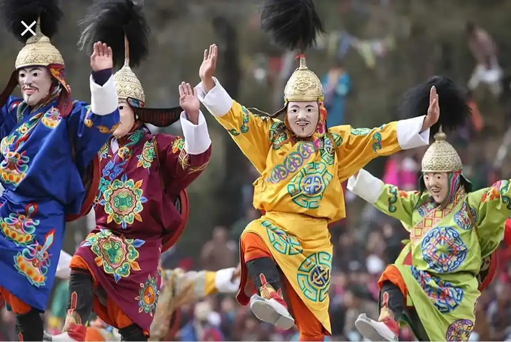Performers in traditional costumes at the Druk Wangyel Tshechu festival in Bhutan