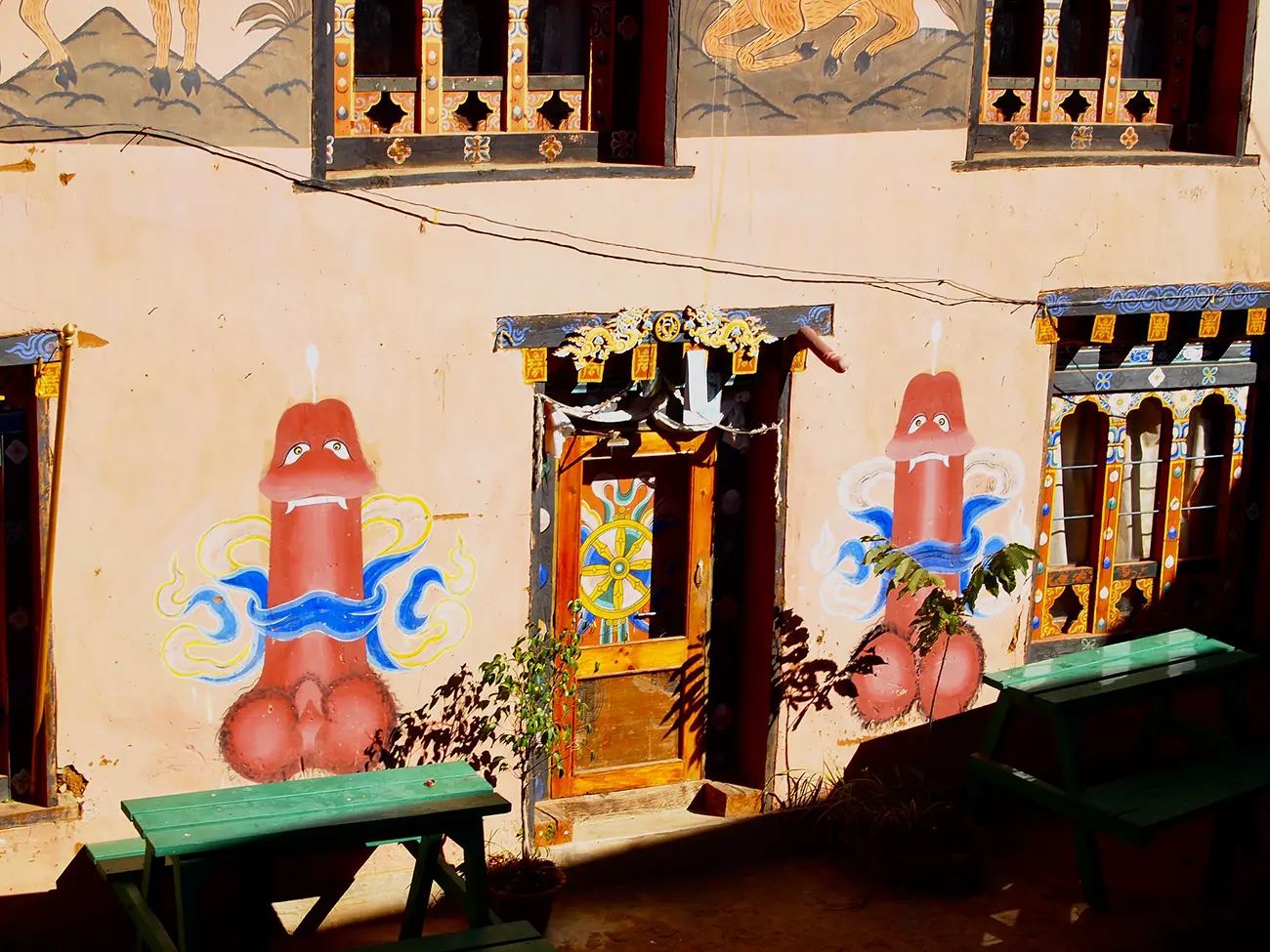 Traditional Bhutanese house with Drukpa Kunley symbols painted on the walls