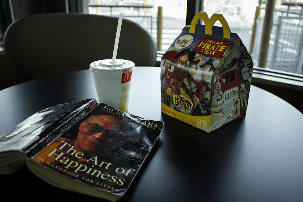 A copy of "The Art of Happiness" by the Dalai Lama on a table