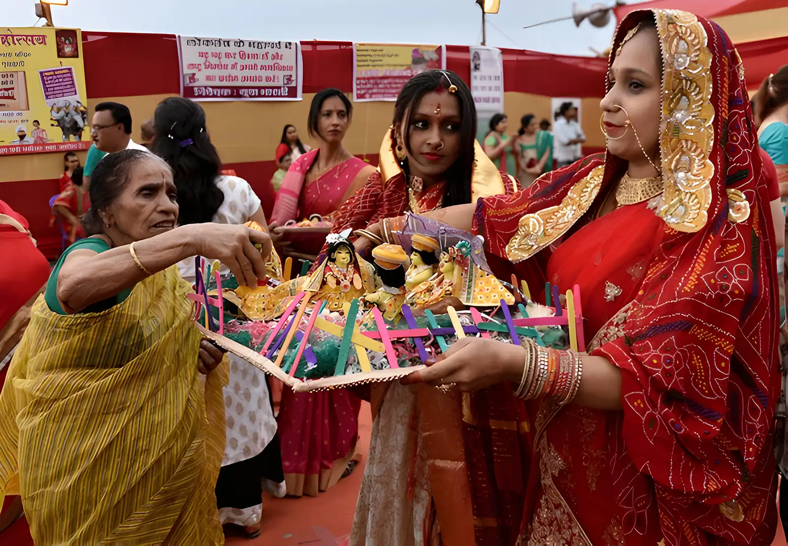 Devotees in vibrant attire carrying a colorful Gangour idol during the Gangour Teej festival in Guwahati.