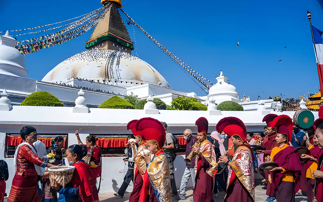 Devotees in traditional dress playing musical instruments during Buddha Jayanti festival at Boudhanath Stupa, Kathmandu.