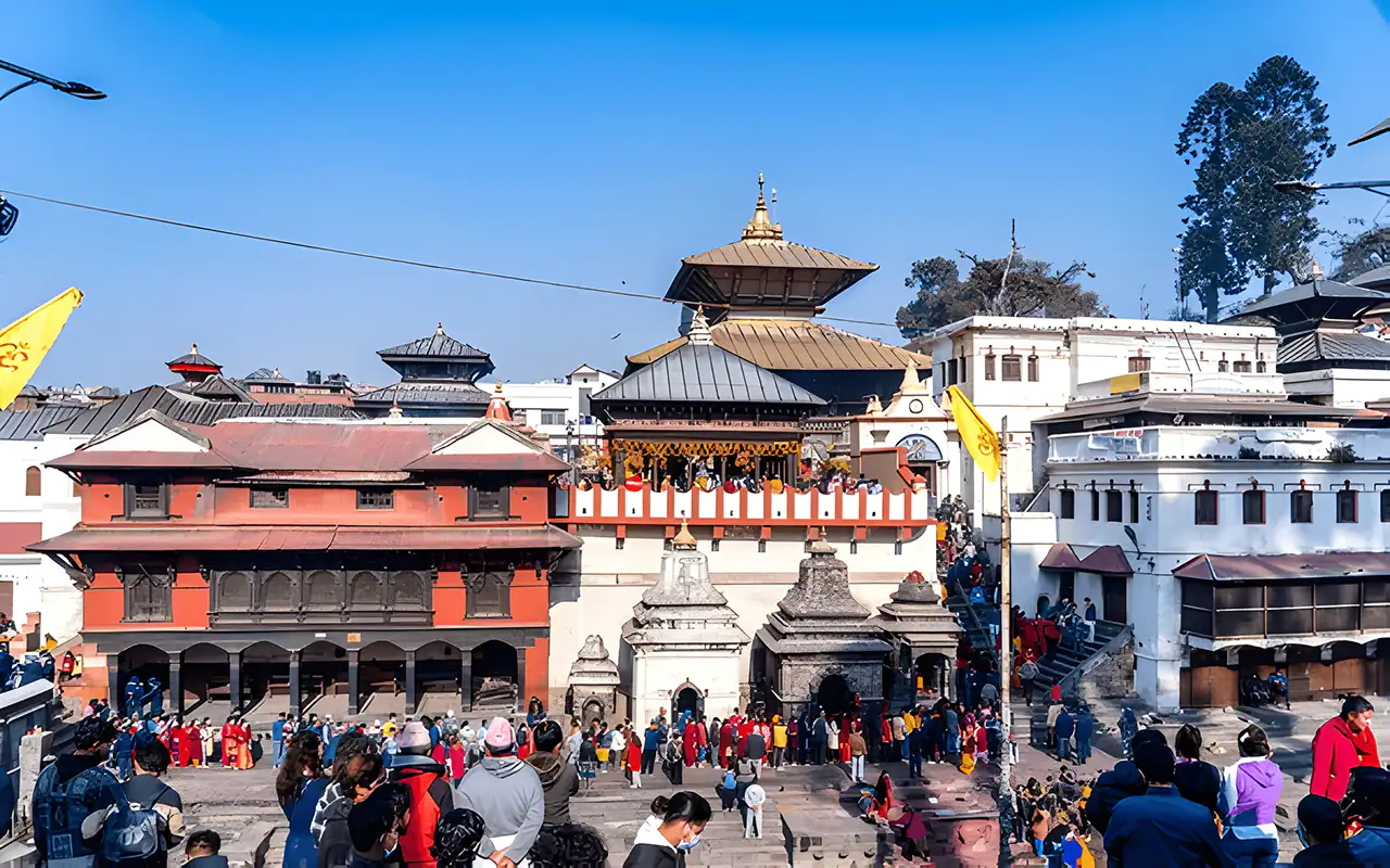 Devotees gather at the Pashupatinath Temple in Kathmandu during Maha Shivaratri, with the temple adorned in vibrant decorations.
