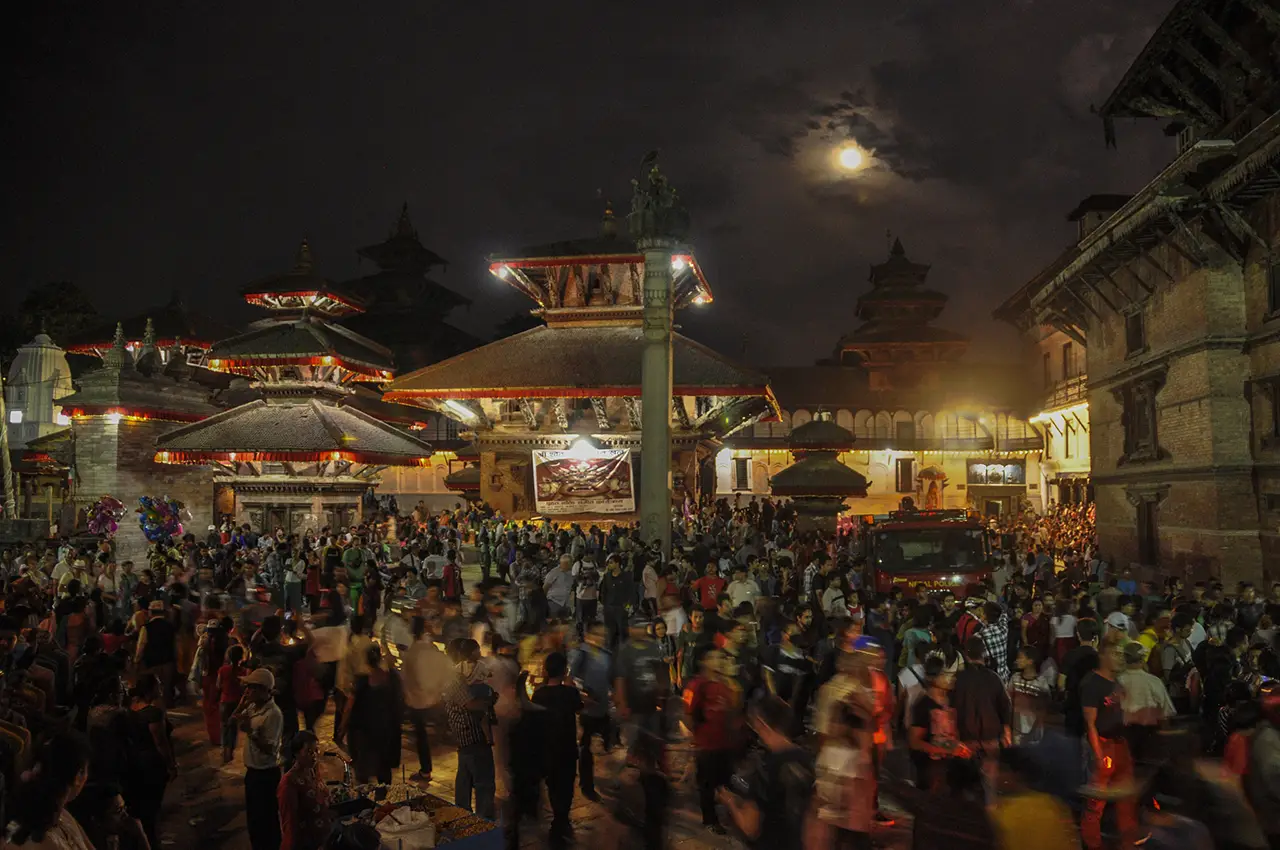 Basantapur Durbar Square illuminated and crowded with people during the Indra Jatra festival in Kathmandu.