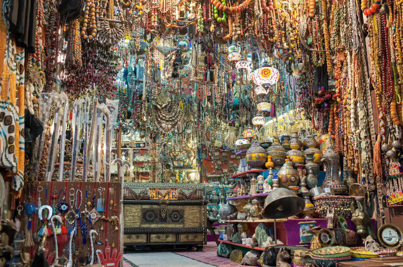 An intricate display of colorful curios at the Mutrah Souk in Muscat, Oman, featuring a variety of traditional handicrafts and ornaments.