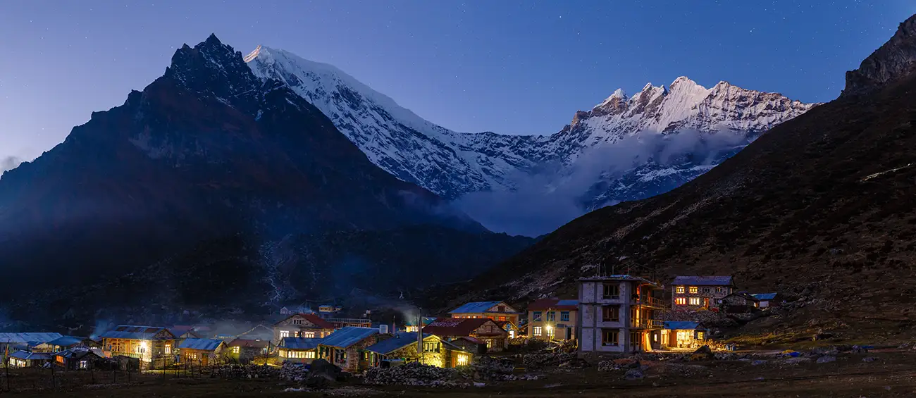 Evening view of Kyangjin Gompa village nestled in the Langtang Valley, with snow-capped mountains in the background.
