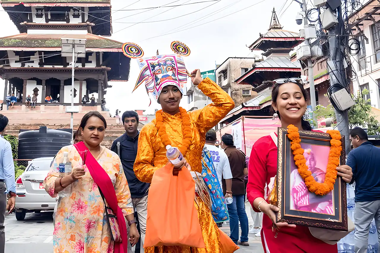 Participants in traditional attire during Gai Jatra Festival in Kathmandu, commemorating the deceased with portraits and symbolic costumes.