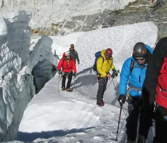 Group of climbers navigating a snow-covered path on Island Peak.