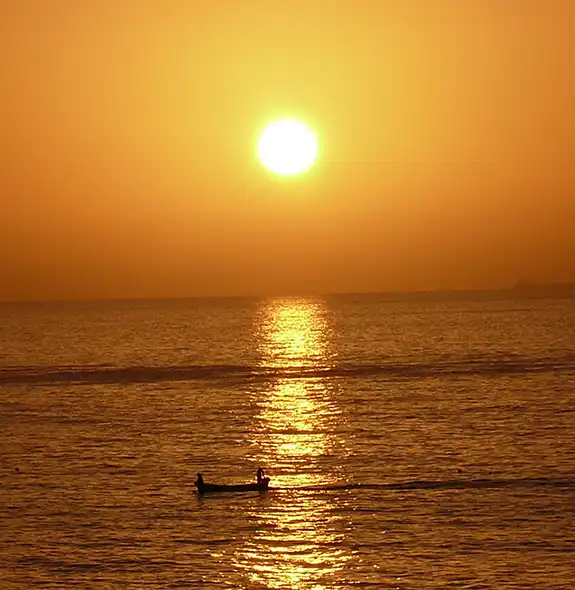 Golden sunrise over the sea at Ras Al-Jinz Turtle Beach in Sur, Oman.