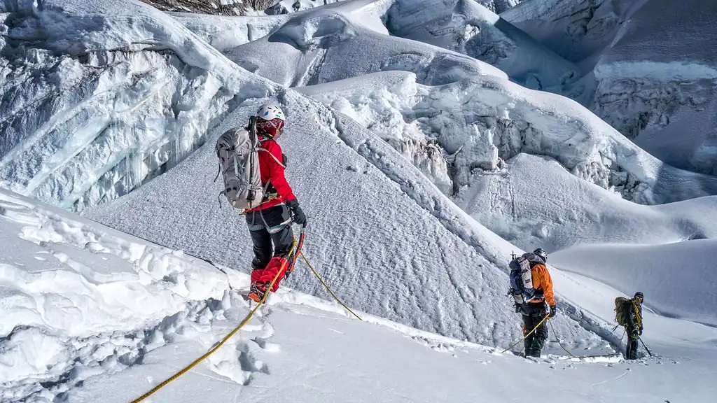 Climbers ascending through a snowy and icy section during the Island Peak climb.
