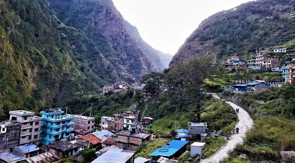 View of Syabrubesi village nestled between lush green mountains in northern Nepal.