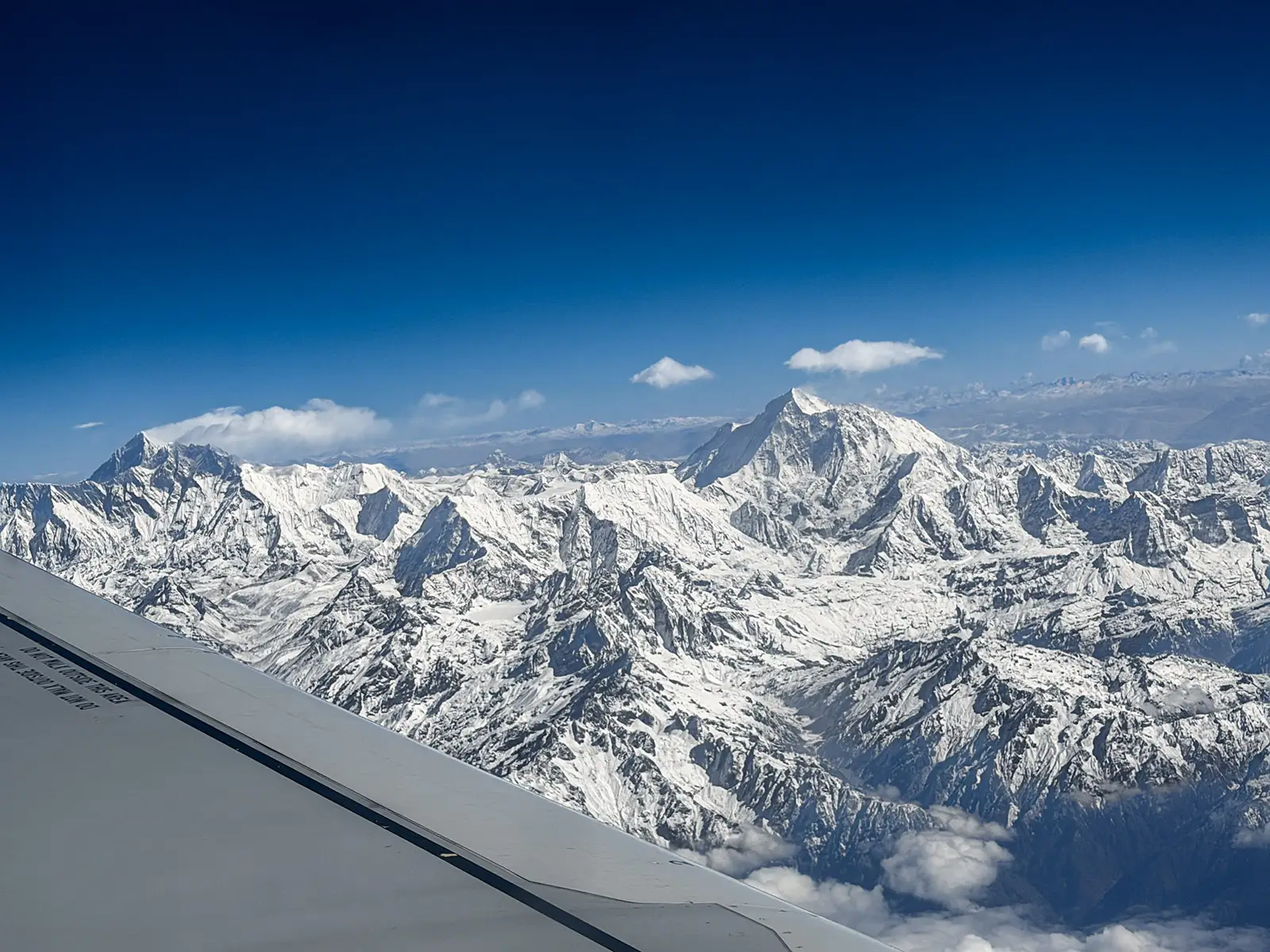 Snow-capped Himalayan peaks viewed from aircraft window on Kathmandu to Paro flight