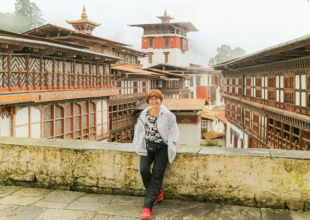rongsa Dzong seen from a distance on a misty day in Bhutan - Bhutan Tour Guide