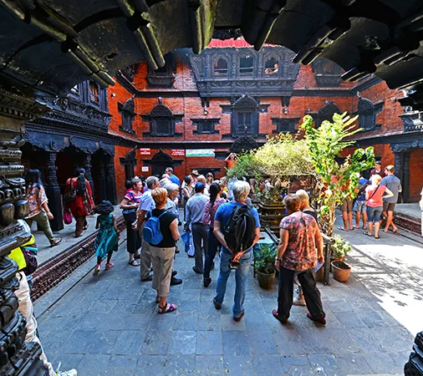 Tourists exploring traditional courtyard in Kathmandu Durbar Squareduring India and Nepal Tour