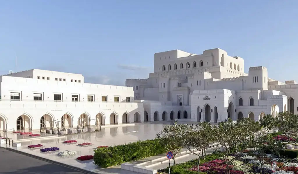 Royal Opera House Muscat in Oman featuring elegant white marble architecture, arches, and landscaped gardens.