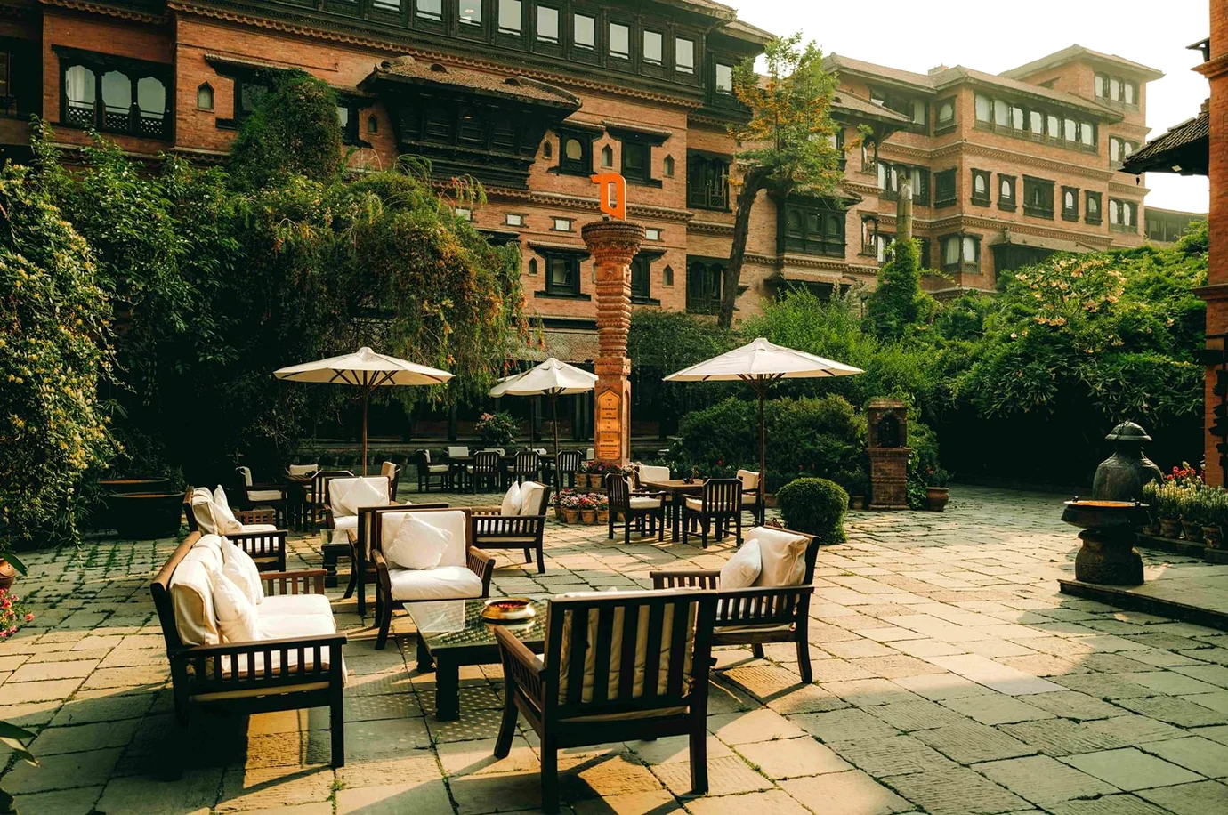 Luxury heritage courtyard at Dwarika’s Hotel with traditional Newari architecture and garden seating