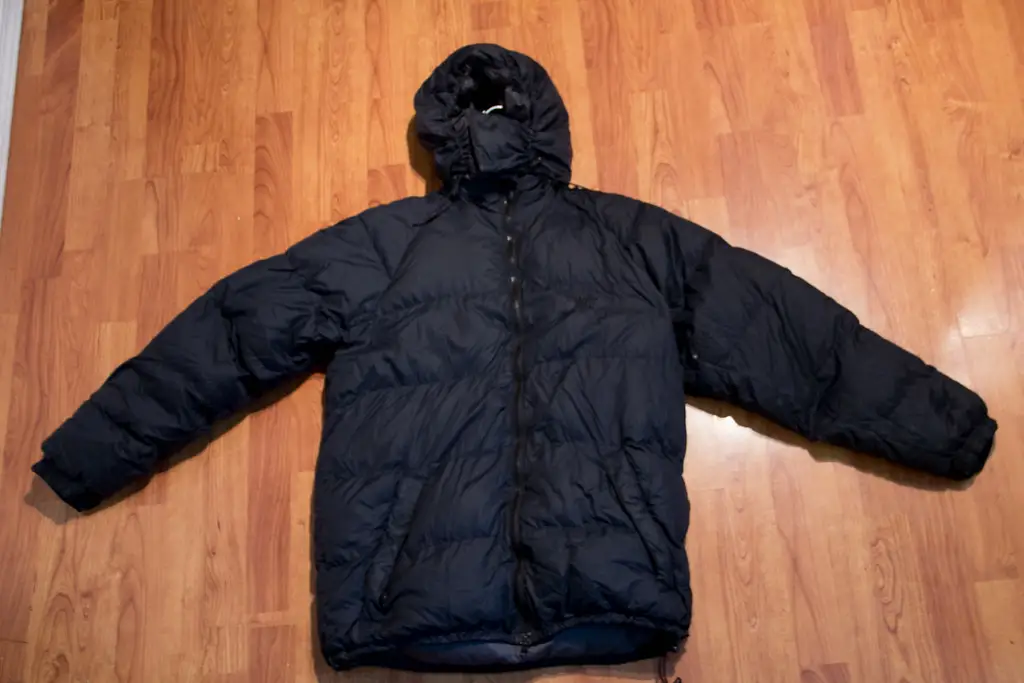 Black insulated down jacket used for high-altitude trekking and cold weather conditions in the Everest region.