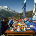 Trekkers enjoying outdoor breakfast during the Luxury Everest Base Camp Trek Food experience with mountain views and fresh meals served at a lodge terrace.