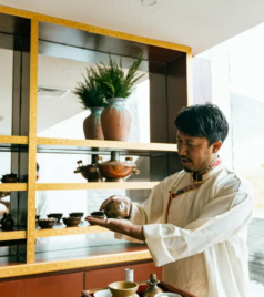 Local practitioner demonstrating traditional herbal medicine inside a wellness space.