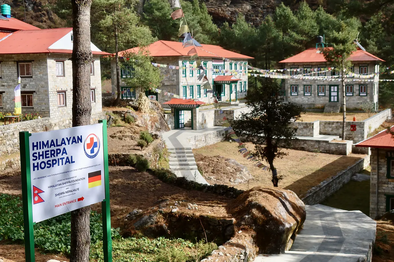 Himalayan Sherpa Hospital in Everest region Nepal with trekking route and mountain village setting