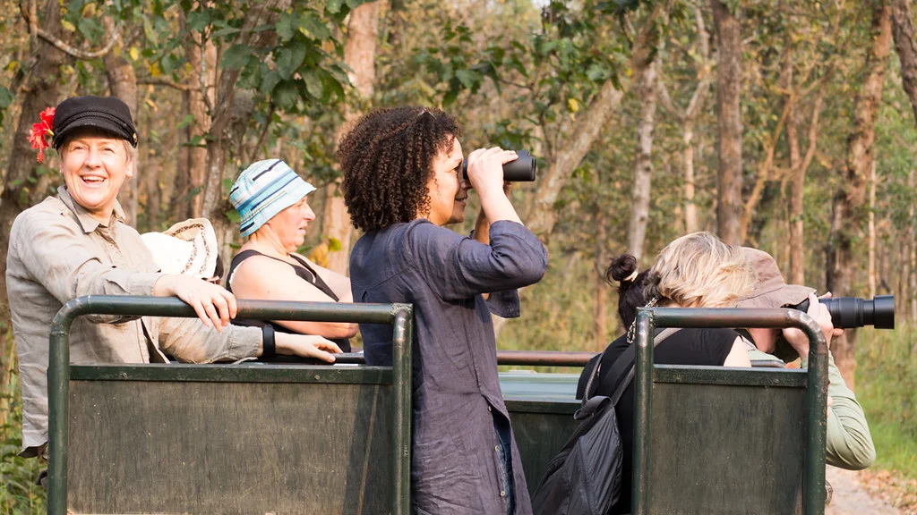Travelers on a jeep safari in Chitwan National Park, enjoying wildlife viewing as part of a standard Nepal tour experience.