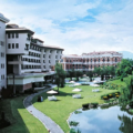 Best 5-Star Hotels in Kathmandu featuring a luxury hotel garden with a pond, manicured lawns, outdoor seating, and elegant buildings under a clear sky