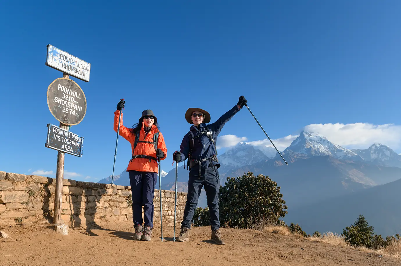 Trekkers at Poon Hill viewpoint Nepal with Annapurna mountain view and clear blue sky