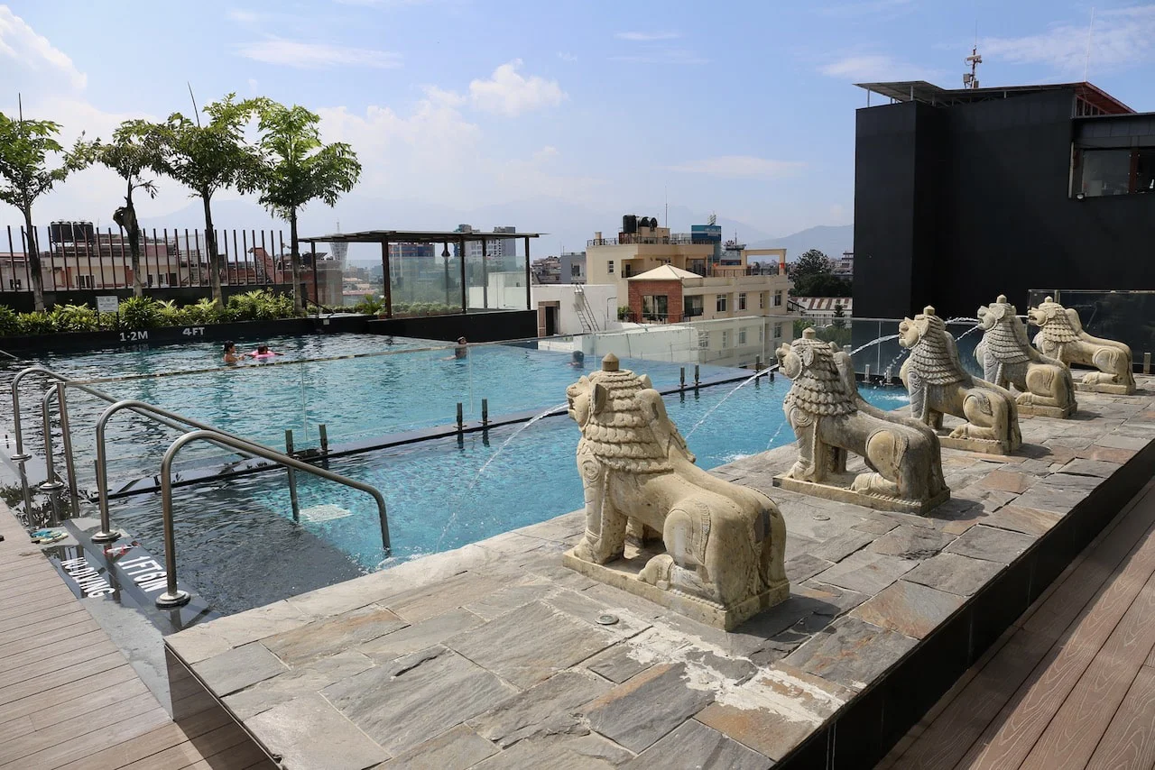 Best 5-Star Hotels in Kathmandu featuring a rooftop infinity pool with stone lion fountains, city views, and a modern luxury hotel setting