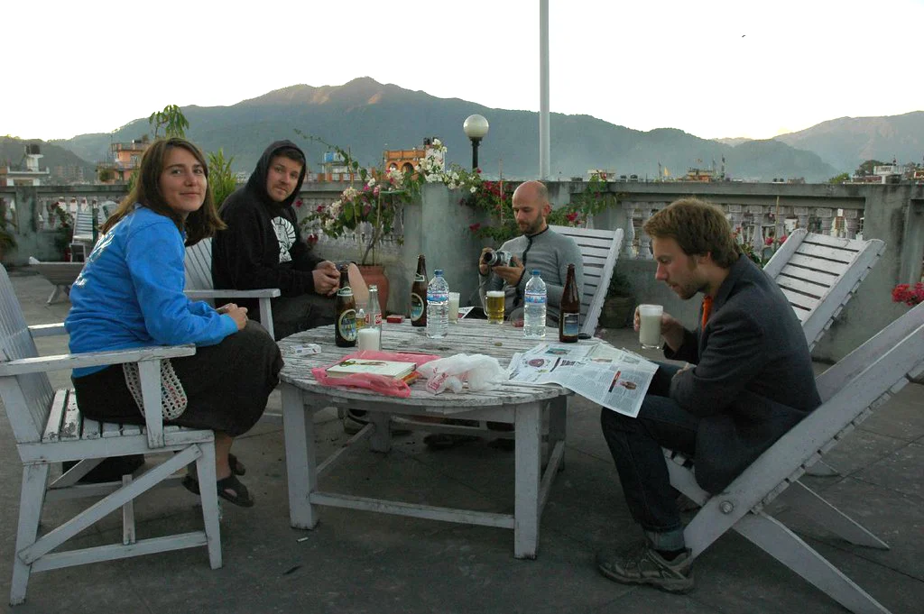 Travelers relaxing on a rooftop terrace at a standard hotel in Kathmandu, showing the simple comfort and shared atmosphere of a standard Nepal tour.