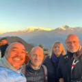 Travelers enjoying sunrise in Sarangkot with Himalayan mountain views during the Best Time for a Luxury Nepal Tour in clear autumn weather.