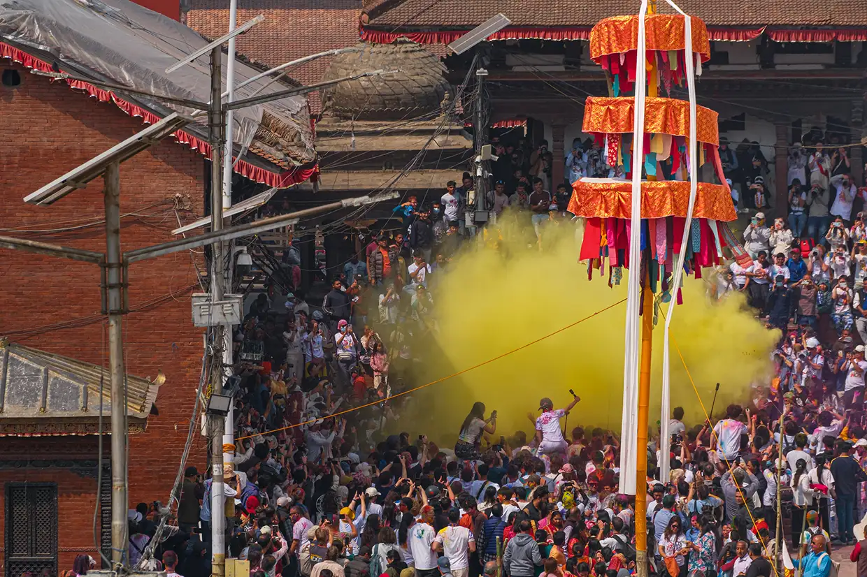 A huge crowd celebrates the Holi festival with yellow powder in Kathmandu, showing the cultural depth of luxury Nepal travel.