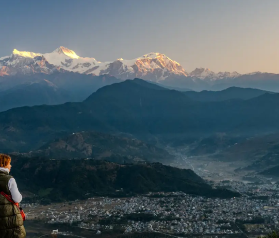 Tourists capture a stunning sunrise over the snow-capped Himalayan peaks from a high lookout, a memorable highlight of a Luxury Kathmandu Pokhara Chitwan Tour.