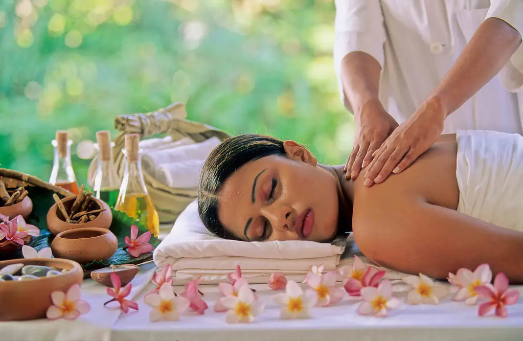 Ayurveda in Sri Lanka is showcased as a guest receives a traditional herbal oil massage during a wellness session.