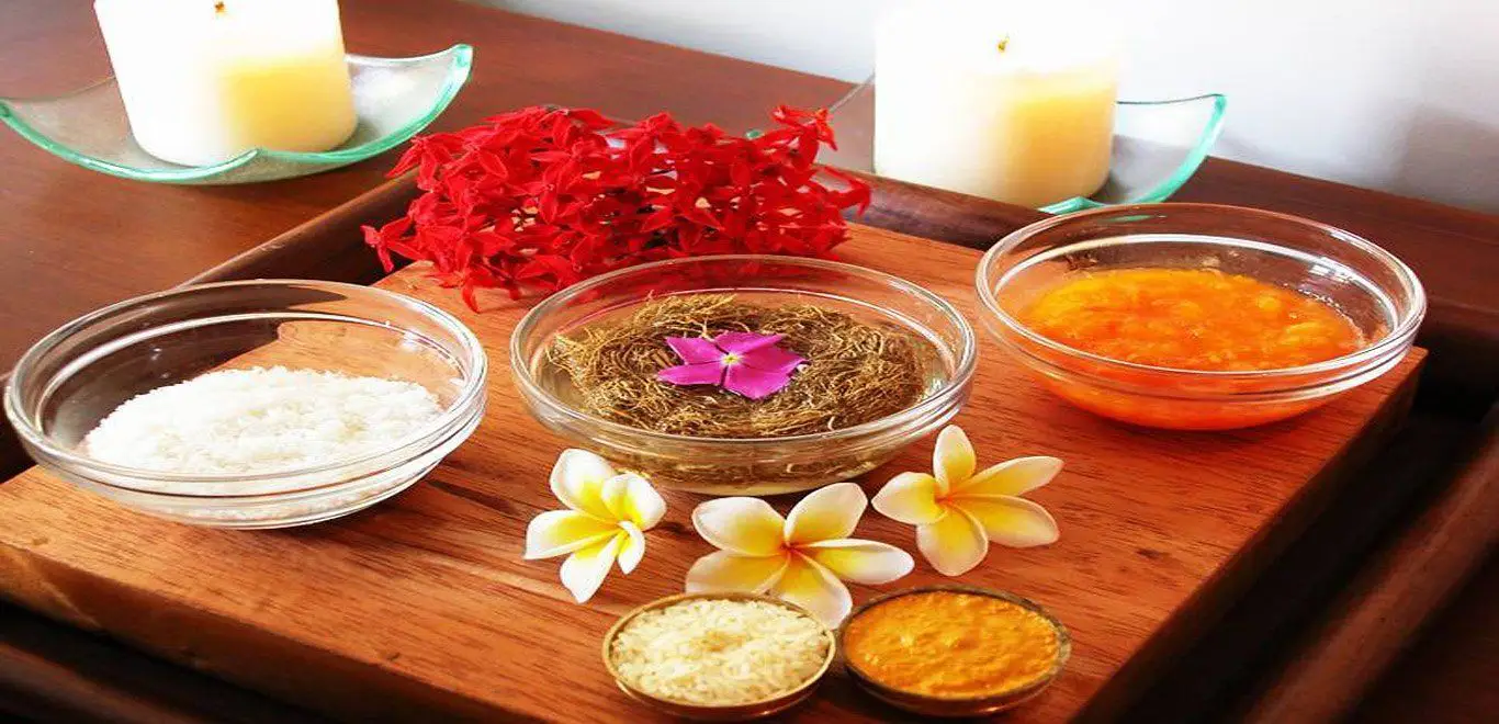 Ayurveda in Sri Lanka is represented by bowls of natural herbal ingredients, oils, and flowers used for traditional treatments.