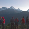 Best Time to Visit Nepal features a group of trekkers admiring panoramic views of snow-capped Himalayan peaks at sunrise.