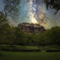 Sri Lanka Itinerary features the ancient Sigiriya Rock Fortress rising above the jungle under a bright Milky Way starry night sky.