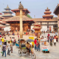 Things to do in Kathmandu features a bustling historic square filled with ancient Newari architecture, temples, and crowds of people.