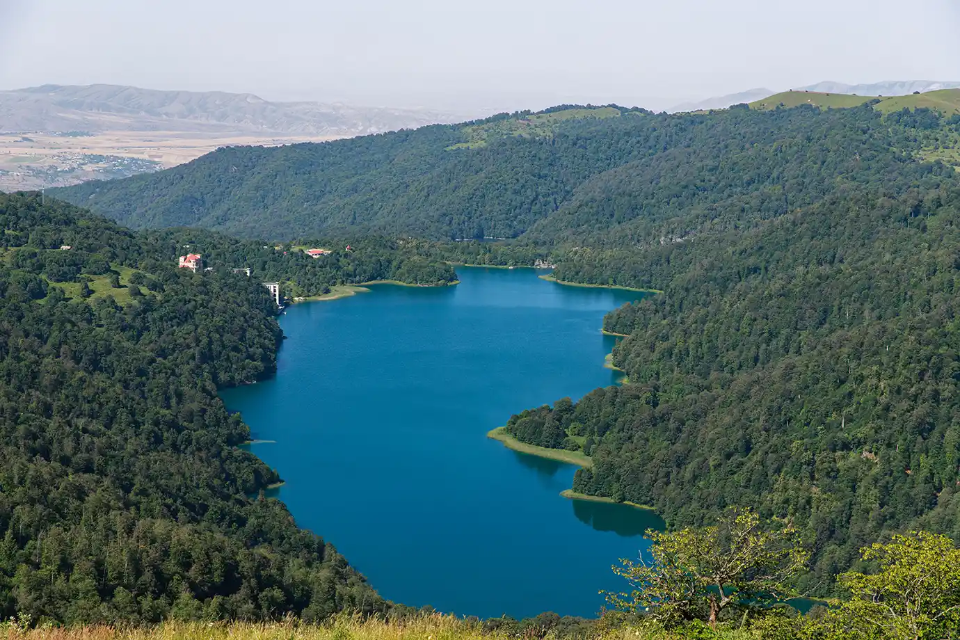 Deep blue alpine waters of Lake Goygol surrounded by dense green forest hills in Goygol National Park featured in a travel guide on 5 Must-Visit Destinations in Azerbaijan Beyond Baku.