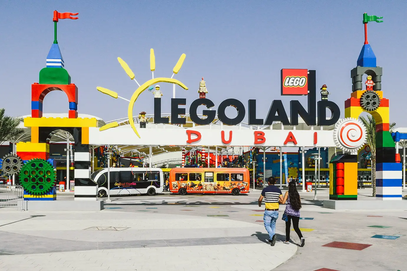 Visitors walking toward the colorful LEGO block entrance sign at Legoland Dubai, a top attraction when exploring Dubai with Kids.