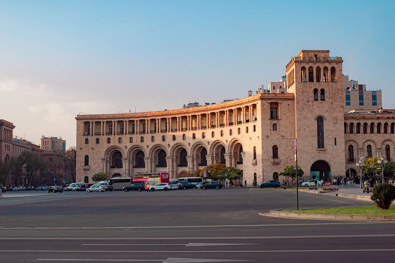 The arched neoclassical facade and clock tower of government buildings at Republic Square featured in a travel guide on The Ultimate 7-Day Armenia Itinerary.