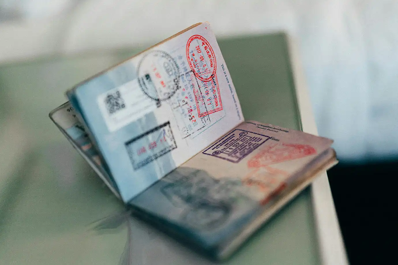 An open passport displaying international entry stamps and travel visas resting on a surface featured in a travel guide on 10 Essential Things to Know Before Visiting Azerbaijan.